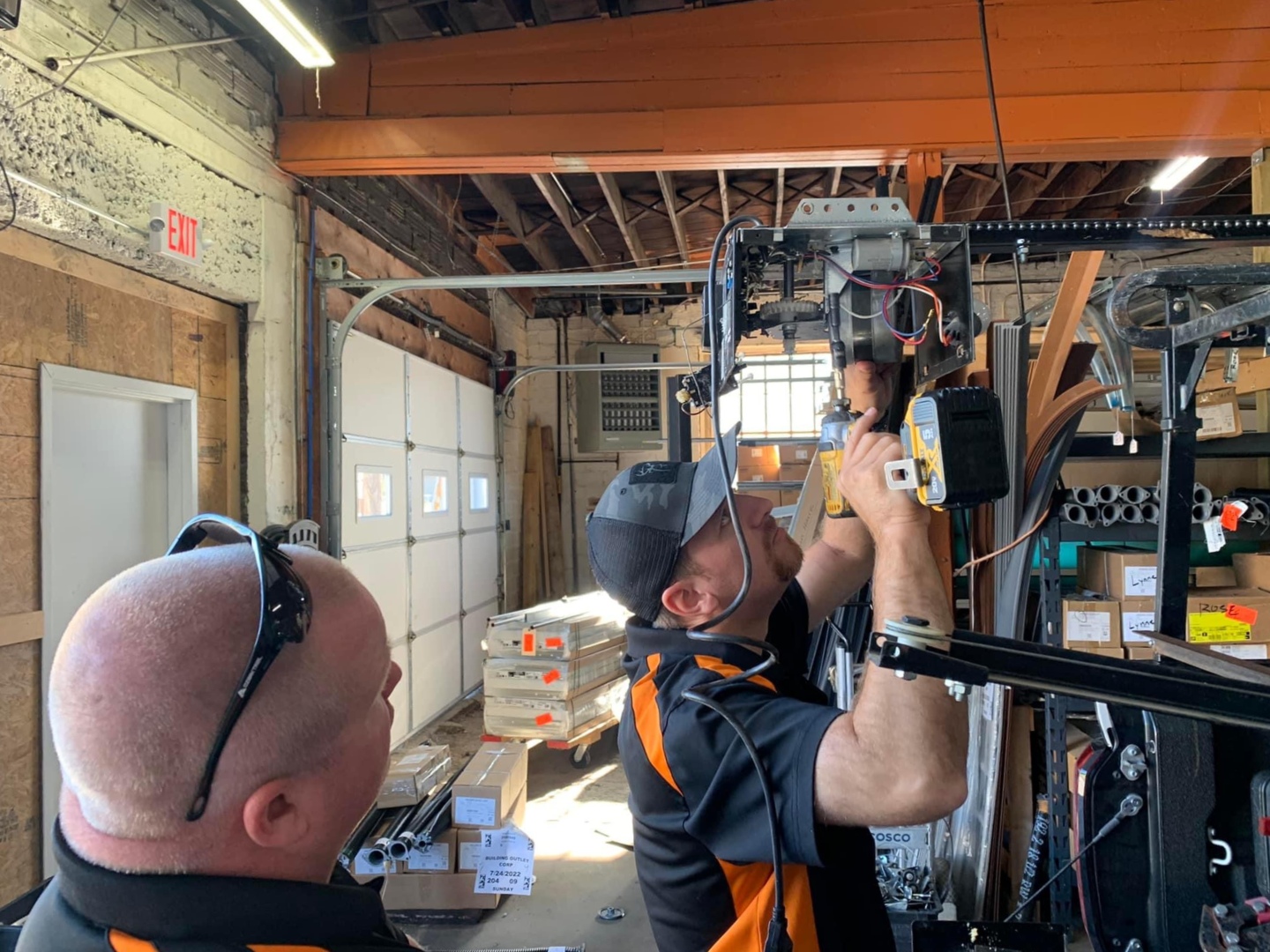 A local garage door company working on a garage door opener motor