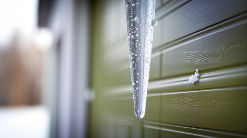 Winter garage door maintenance could prevent icing over as seen in this picture and other cold-weather problems.